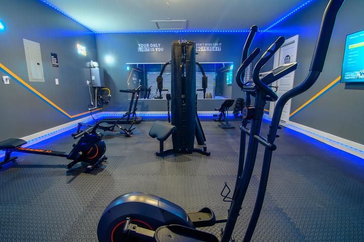Converted garage gym with blue LED lighting